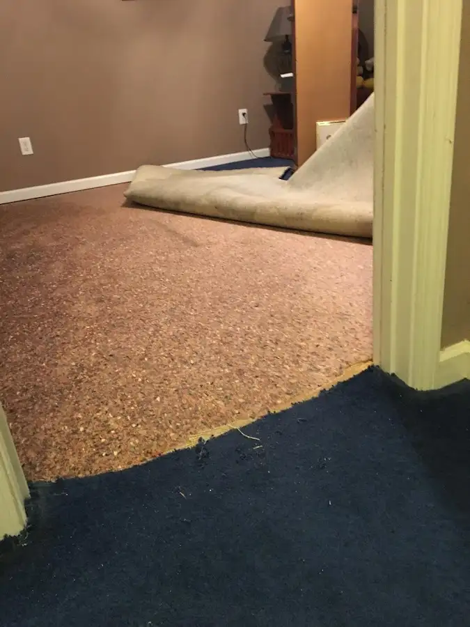 Carpet pad removal revealing water damage during Water Mitigation Services in Canyon