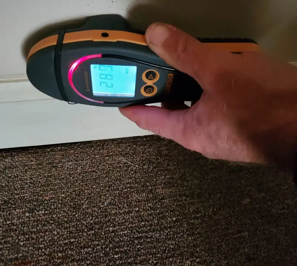 Moisture detection at baseboard during Storm Damage Restoration in Canyon